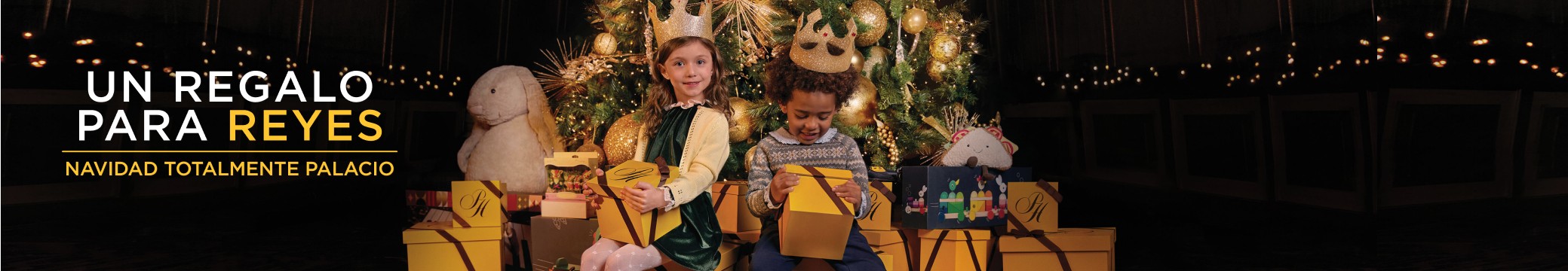 imagen de niña y niño a los pies de un arbol de navidad con regalo amarillo en las manos, 50 % de descuento + 6 mensualidades de descuento + envio gratis, Un regalo para reyes