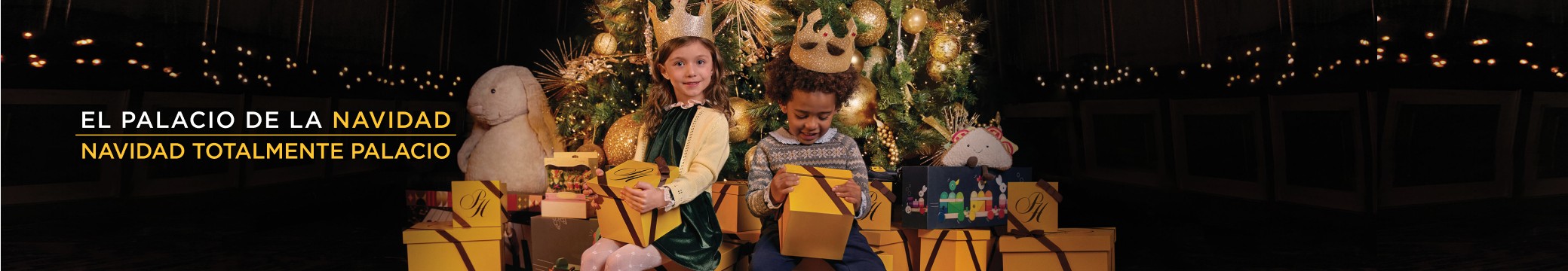 imagen de niña y niño a los pies de un arbol de navidad con regalo amarillo en las manos, 20 % de descuento + 6 mensualidades de descuento + envio gratis, Navidad total mente palacio 2024